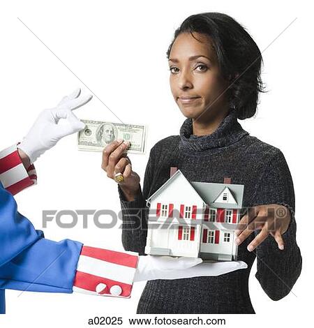 Mid adult woman holding model house and paying for it, studio shot View Large Photo Image Stock Photography - Mid adult woman holding model house and paying for it, studio shot. Fotosearch