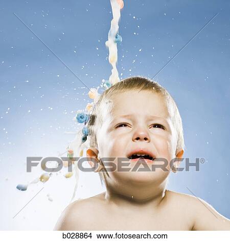 milk and cereal pouring onto a baby's head View Large Photo Image Picture - milk and cereal pouring onto a baby's head. Fotosearch