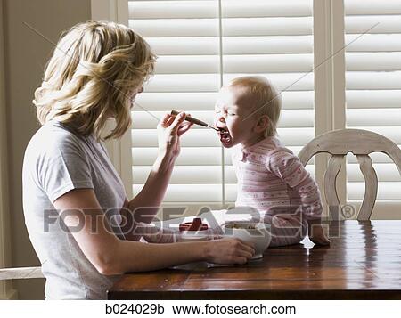 mother and baby girl at the breakfast table View Large Photo Image Stock Image - mother and baby girl at the breakfast table. Fotosearch