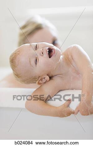 Picture - mother and baby taking a bubble bath. Fotosearch