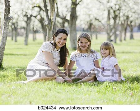 mother and daughters in a blossoming orchard View Large Photo Image Picture - mother and daughters in a blossoming orchard. Fotosearch