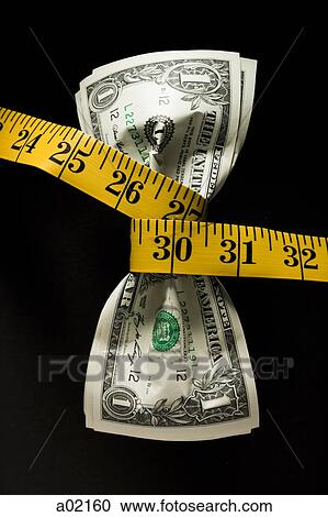 Stock Image - One dollar banknotes tied up with measuring tape against black background. Fotosearch