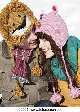 Stock Photo - Orem, Utah, USA, boyfriend and girlfriend wearing funny knit hats, embracing. Fotosearch