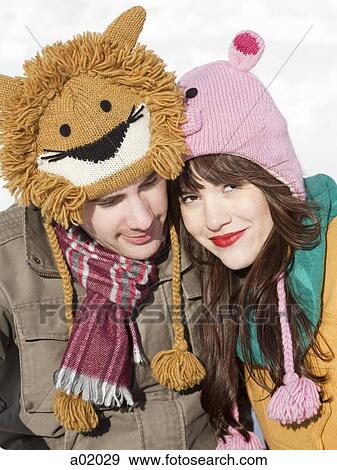 Stock Photo - Orem, Utah, USA, boyfriend and girlfriend wearing funny knit hats, portrait. Fotosearch
