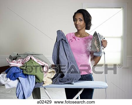 Orem, Utah, USA, mid adult woman ironing View Large Photo Image Stock Photo - Orem, Utah, USA, mid adult woman ironing. Fotosearch