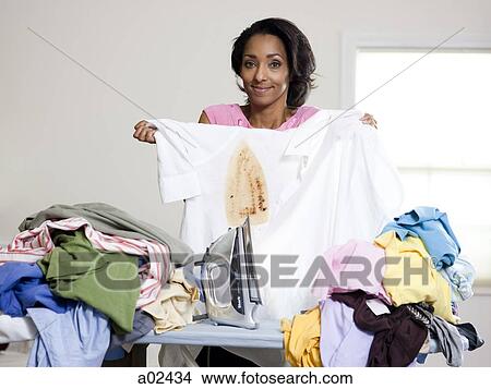 Orem, Utah, USA, mid adult woman holding burnt shirt View Large Photo Image Picture - Orem, Utah, USA, mid adult woman holding burnt shirt. Fotosearch