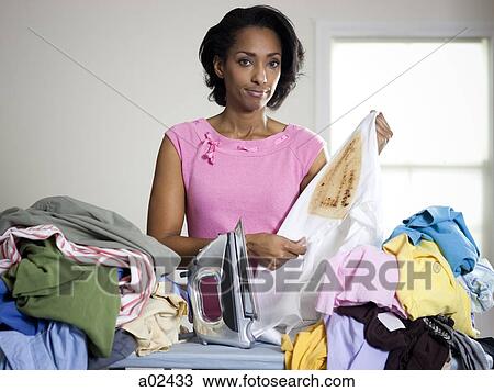 Orem, Utah, USA, mid adult woman holding burnt shirt View Large Photo Image Stock Image - Orem, Utah, USA, mid adult woman holding burnt shirt. Fotosearch