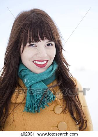 Stock Image - Orem, Utah, USA, young woman in turquoise scarf and red lipstick smiling, portrait. Fotosearch