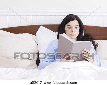 Orem, Utah, USA, young woman reading book in bed View Large Photo Image Stock Photo - Orem, Utah, USA, young woman reading book in bed. Fotosearch
