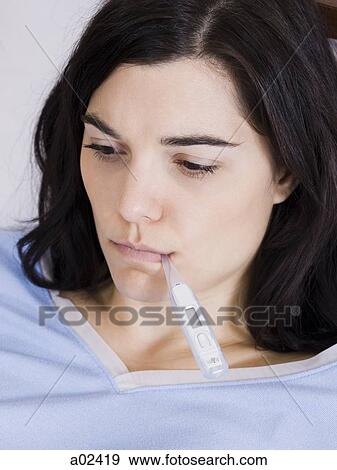 Orem, Utah, USA, young woman with thermometer in mouth View Large Photo Image Stock Photo - Orem, Utah, USA, young woman with thermometer in mouth. Fotosearch