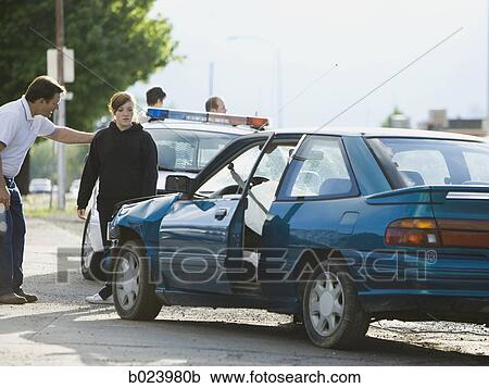 Stock Image - people looking at a car after an accident. Fotosearch
