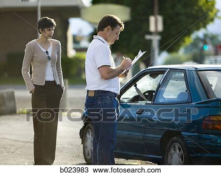 Stock Image - people looking at a car after an accident. Fotosearch