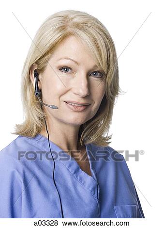 Stock Photo - Portrait of female nurse using headset. Fotosearch