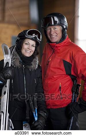 Stock Image - Portrait of mature couple going skiing. Fotosearch