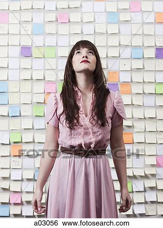 Portrait of woman in room with walls covered with adhesive notes View Large Photo Image Stock Photograph - Portrait of woman in room with walls covered with adhesive notes. Fotosearch