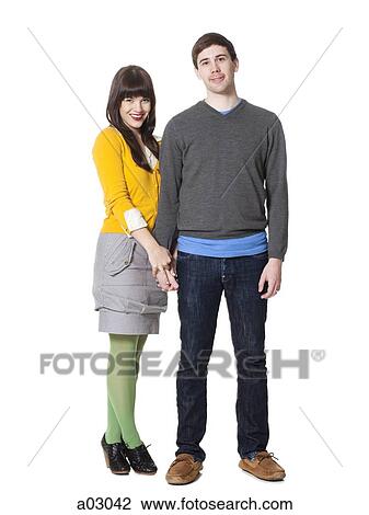 Stock Image - Portrait of young couple, studio shot. Fotosearch