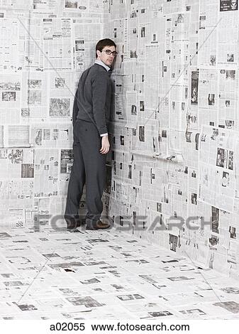 Portrait of young man standing in newspaper room View Large Photo Image Stock Photography - Portrait of young man standing in newspaper room. Fotosearch