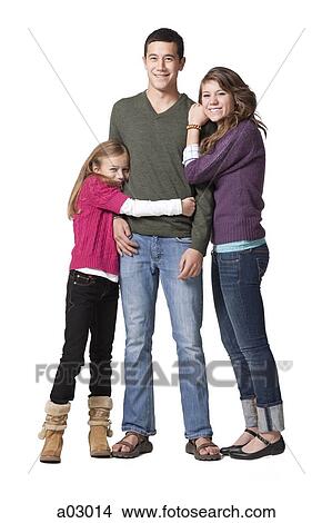 Picture - Portrait of young man with teenage girl (16-17) and primary age girl (8-9), studio shot. Fotosearch