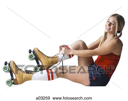 Portrait of young woman tying roller skates View Large Photo Image Stock Photo - Portrait of young woman tying roller skates. Fotosearch