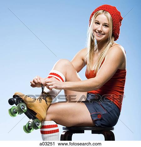 Portrait of young woman wearing roller skates View Large Photo Image Stock Image - Portrait of young woman wearing roller skates. Fotosearch