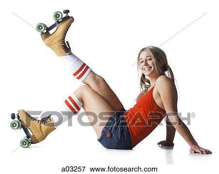 Portrait of young woman wearing roller skates View Large Photo Image Stock Photo - Portrait of young woman wearing roller skates. Fotosearch