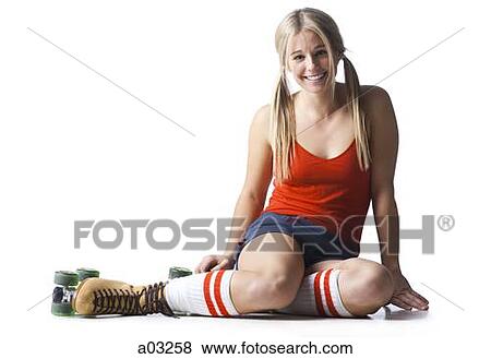 Stock Photo - Portrait of young woman wearing roller skates. Fotosearch