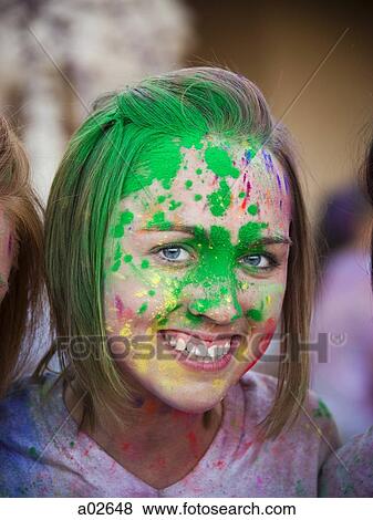Stock Photo - Portrait of young woman with face covered by paint. Fotosearch