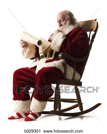 santa claus sitting in a rocking chair going over his list View Large Photo Image Stock Image - santa claus sitting in a rocking chair going over his list. Fotosearch