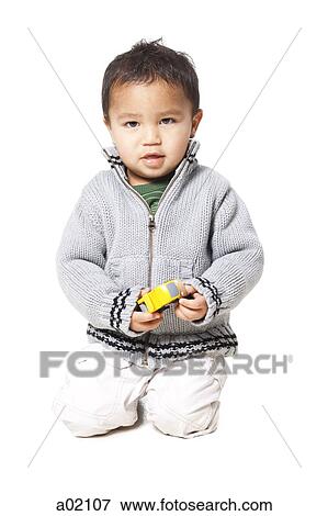 Studio portrait of baby boy (18-23 months) playing with toy car View Large Photo Image Stock Photo - Studio portrait of baby boy (18-23 months) playing with toy car. Fotosearch