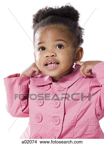 Picture - Studio portrait of baby girl (18-23 months) wearing pink coat. Fotosearch
