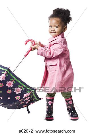 Studio portrait of baby girl (18-23 months) holding umbrella View Large Photo Image Stock Image - Studio portrait of baby girl (18-23 months) holding umbrella. Fotosearch