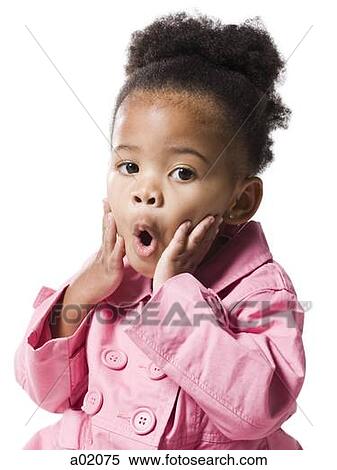 Stock Photography - Studio portrait of baby girl (18-23 months) wearing pink coat. Fotosearch