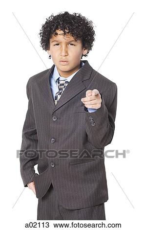 Studio portrait of boy (8-9) wearing suit, pointing View Large Photo Image Stock Image - Studio portrait of boy (8-9) wearing suit, pointing. Fotosearch
