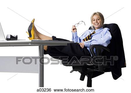 Studio portrait of businesswoman relaxing at desk View Large Photo Image Stock Photograph - Studio portrait of businesswoman relaxing at desk. Fotosearch