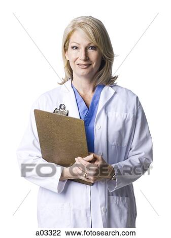 Studio portrait of female doctor holding clipboard View Large Photo Image Stock Image - Studio portrait of female doctor holding clipboard. Fotosearch