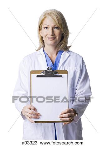 Stock Image - Studio portrait of female doctor holding blank clipboard. Fotosearch
