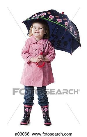 Stock Photograph - Studio portrait of girl (2-3) holding umbrella. Fotosearch