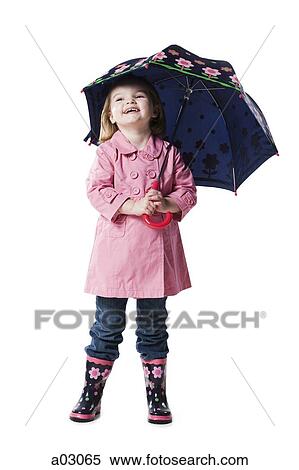 Stock Photography - Studio portrait of girl (2-3) holding umbrella. Fotosearch