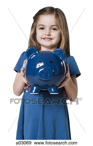 Studio portrait of girl (4-5) holding piggy bank View Large Photo Image Stock Photo - Studio portrait of girl (4-5) holding piggy bank. Fotosearch