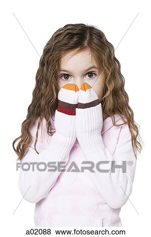 Studio portrait of girl (6-7) covering face View Large Photo Image Stock Photo - Studio portrait of girl (6-7) covering face. Fotosearch