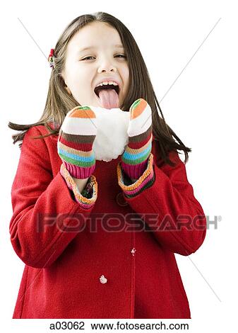 Studio portrait of girl (6-7) licking snowball View Large Photo Image Stock Image - Studio portrait of girl (6-7) licking snowball. Fotosearch