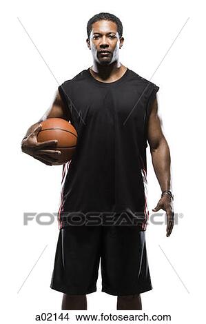 Picture - Studio portrait of male basketball player holding ball. Fotosearch