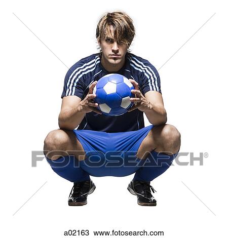 Studio portrait of soccer player holding ball View Large Photo Image Stock Image - Studio portrait of soccer player holding ball. Fotosearch