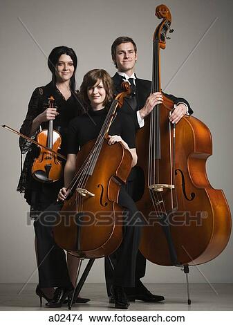 Studio portrait of three young musicians with instruments View Large Photo Image Picture - Studio portrait of three young musicians with instruments. Fotosearch
