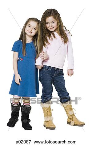 Studio portrait of two girls (4-7) arm in arm View Large Photo Image Stock Photo - Studio portrait of two girls (4-7) arm in arm. Fotosearch