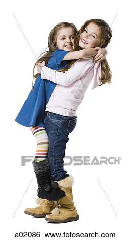 Studio portrait of two girls (4-7) embracing View Large Photo Image Stock Photograph - Studio portrait of two girls (4-7) embracing. Fotosearch