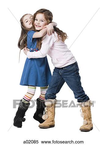 Studio portrait of two girls (4-7) embracing View Large Photo Image Stock Photography - Studio portrait of two girls (4-7) embracing. Fotosearch