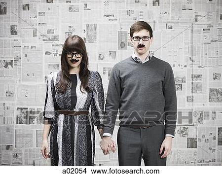 Picture - Studio portrait of young couple wearing fake moustaches. Fotosearch