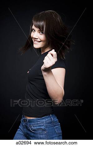 Studio portrait of young woman dancing View Large Photo Image Picture - Studio portrait of young woman dancing. Fotosearch