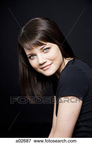 Studio portrait of young woman View Large Photo Image Stock Photo - Studio portrait of young woman. Fotosearch